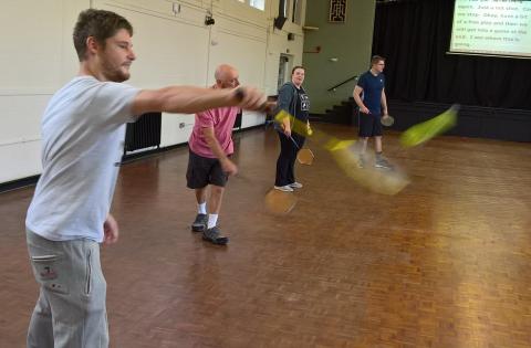 Members of the deaf awareness: NE badminton club taking part in a training exercise