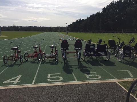 A picture of some adaptive cycles on the athletics track