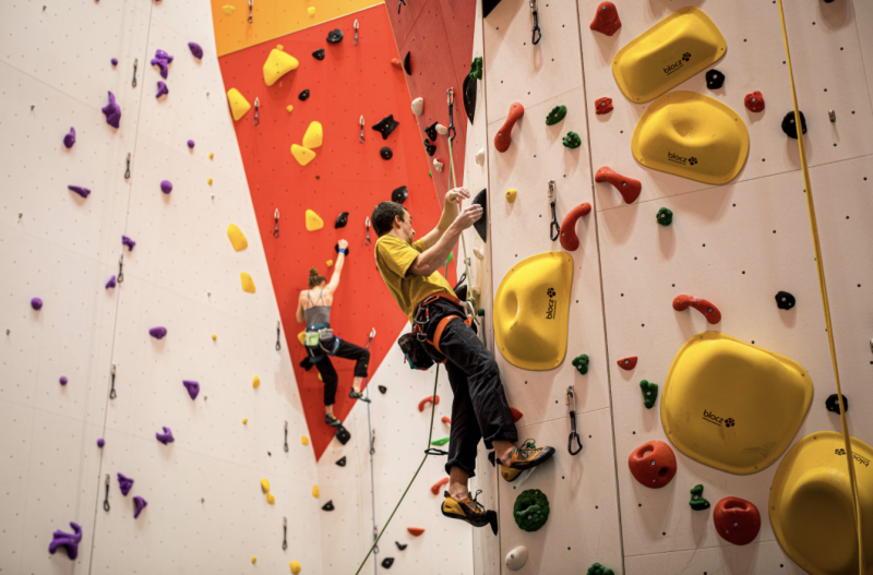 2 lead-climbers are shown in the roped climbing area of The Arc. Both are half way up the wall mid-climb.