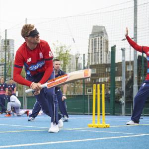 People playing cricket with blindfolds on