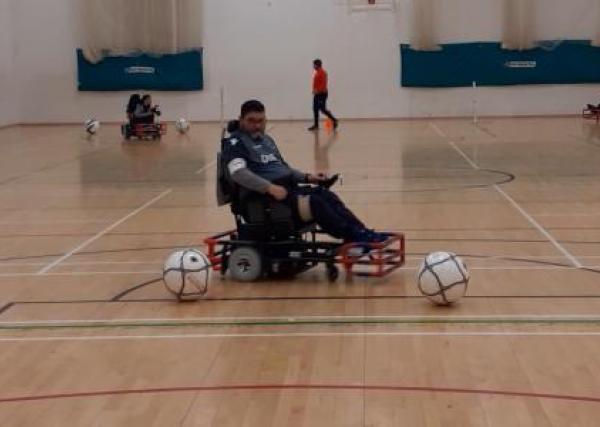 Powerchair football player in a sports hall