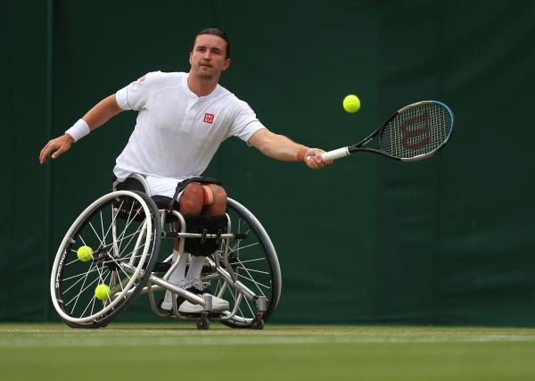 Gordon Reid, wheelchair tennis athlete, mid forehand shot at Wimbledon 2023